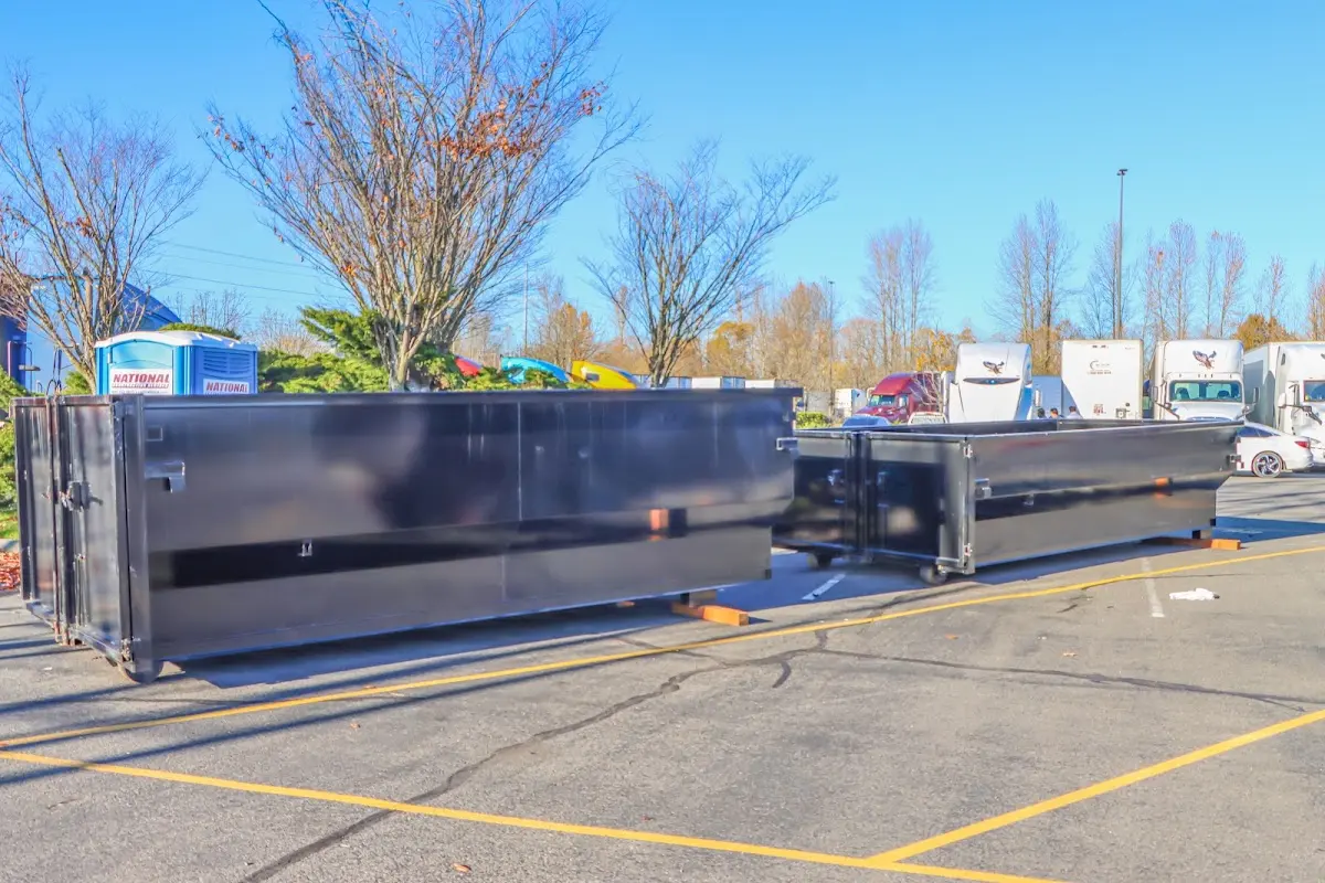 Professional dumpster rental service with roll-off container on residential driveway in Spokane